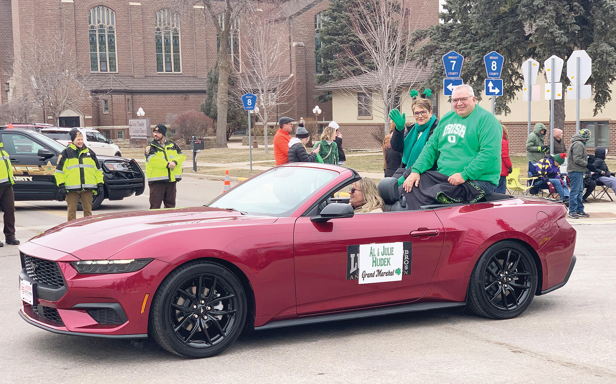 Judy Hudek waives to onlookers while husband, Al, is all smiles during the 49th annual St. Patrick’s Day Festival parade in Maple Lake last Saturday. The Hudek’s served as grand marshals of the parade, an honor bestowed upon Maple Lake residents who display outstanding service to the community. (Photos by Mike Gesellchen)