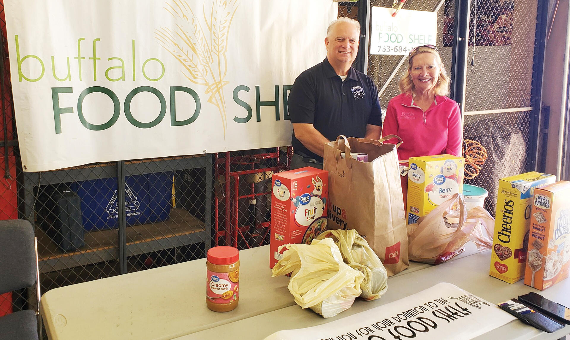 Many local organizations and groups collect items at area food drives throughout the year. This cereal drive was sponsored by the Buffalo Police Department during an open house event. Pictured is Community Service Officer Tony Daniels and Food Shelf Executive Director Laureen Bodin.