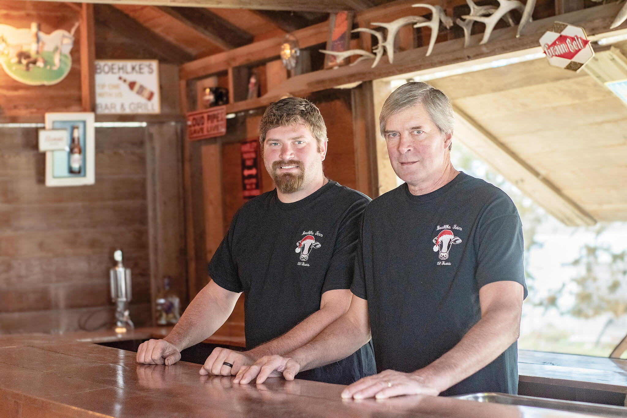 The Boehlke family farm has seen its fair share of celebrations over the years, including weddings, graduations, and old-fashioned bar dances. A bar room was added on the property that is still in use today. Pictured at left is Eugene Jr. along with his father, Eugene Sr.