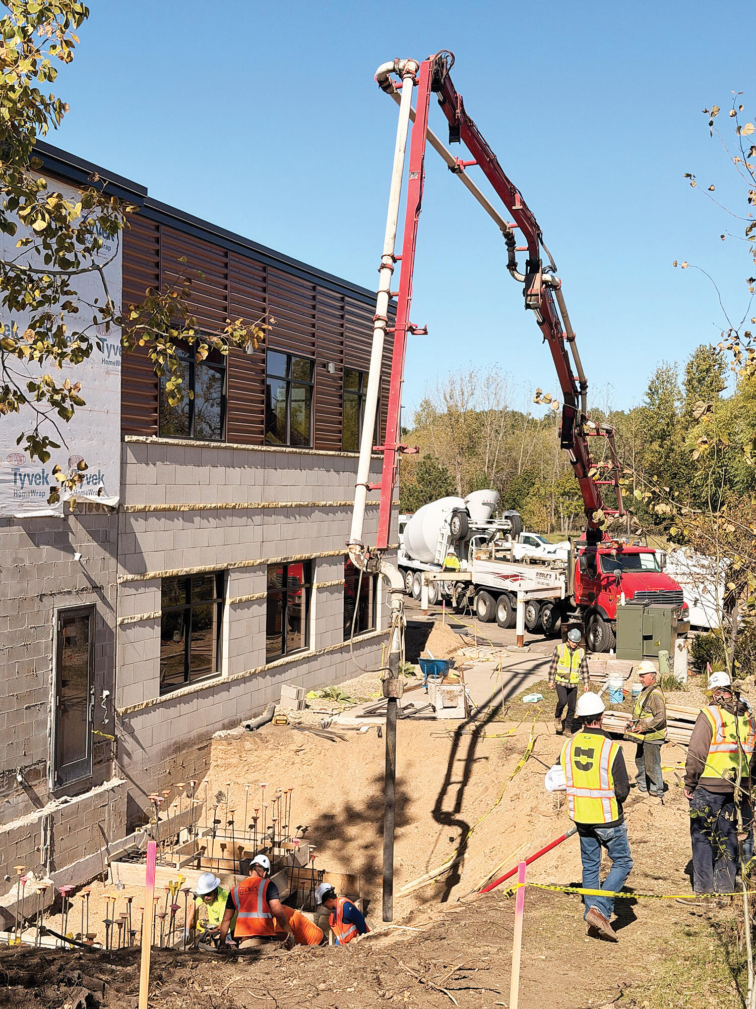 Concrete is poured to create the foundation for the external elevator entrance.
