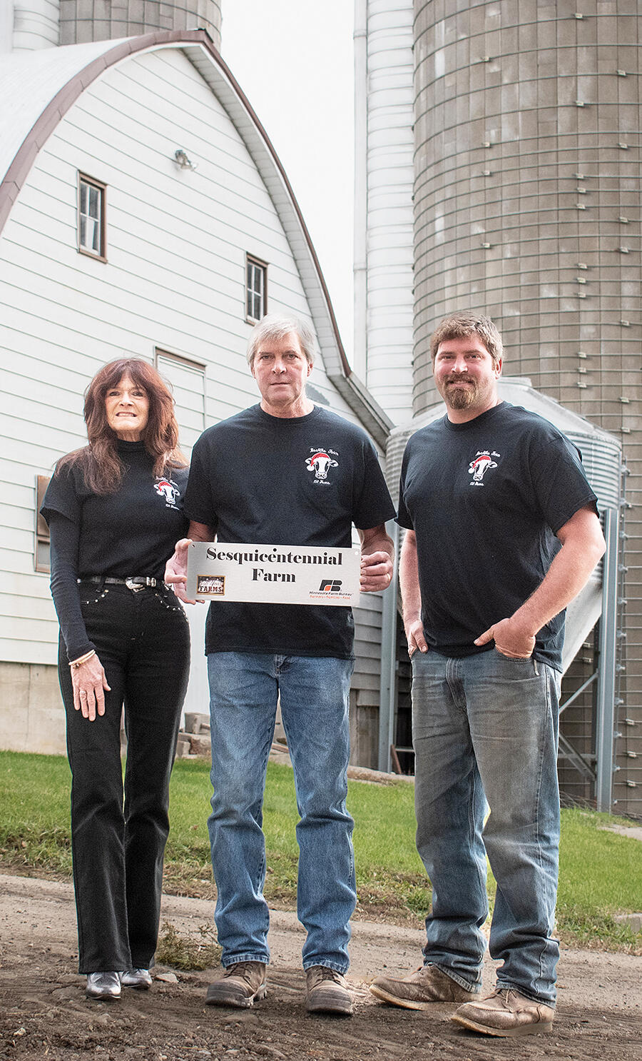 Rita, Eugene Sr., and son, Eugene Jr., stand proudly with their sesquicentennial sign.