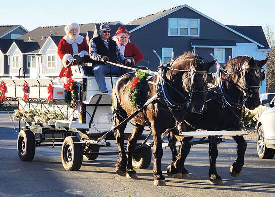 Mr. and Mrs. Clause get in on the fun, as Ken takes the reins for a team of two heading down the street. (Photo submitted by Joleen Olson)