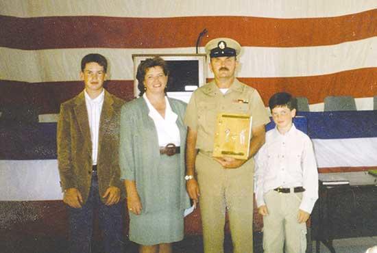 Above, Edwards is pictured at a ceremony for promotion to Construction Election Chief Petty Officer.Pictured with him, left to right, are: son, Chris; wife, Marty; Chief Scott Edwards; and son, Nick.