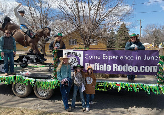 Buffalo Rodeo representatives pause for a photo as they prepare their float to travel down the parade route.