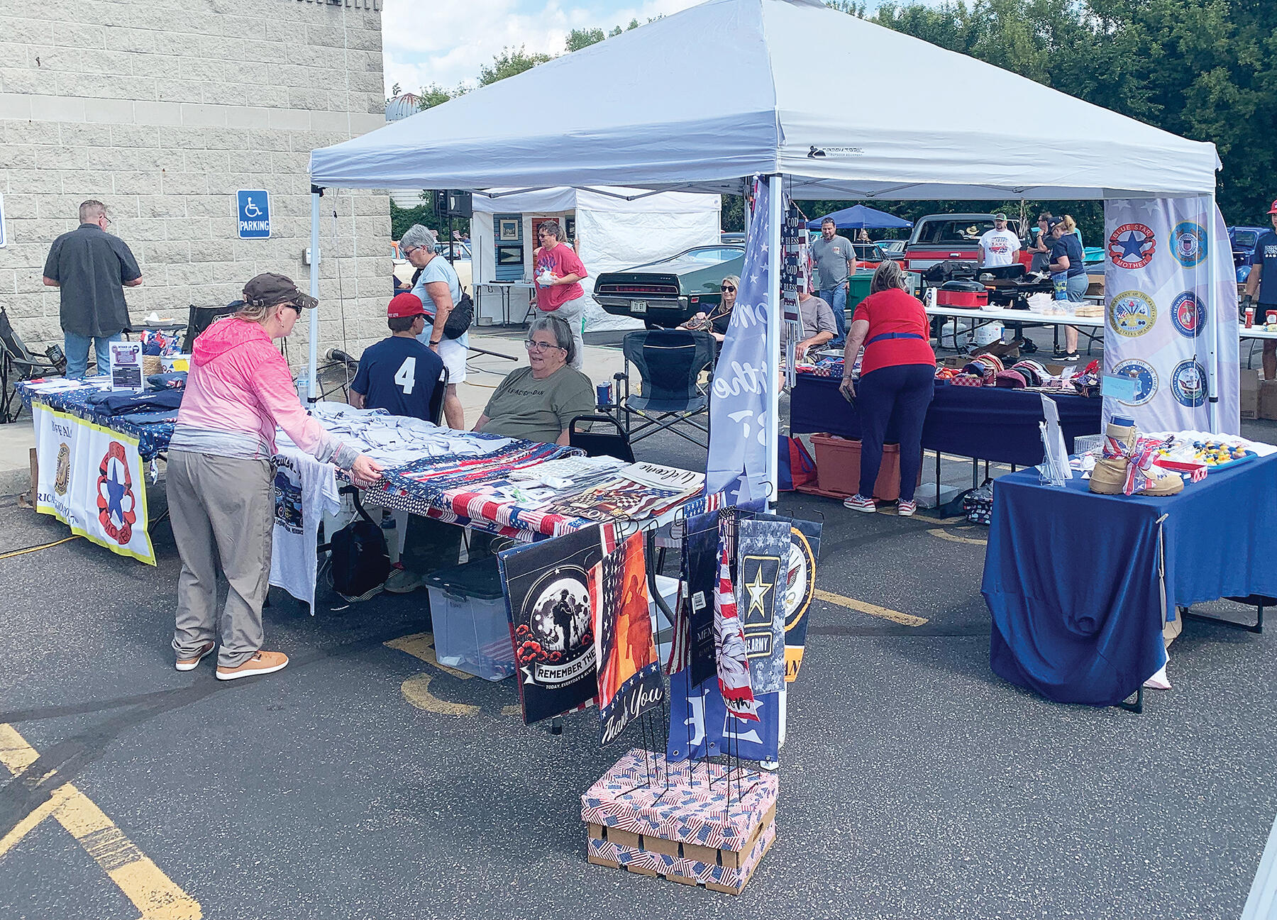 Volunteers with Blue Star Mothers educated passersby on the service work done by the organization and sold merchandise to raise money in support of active personnel, veterans, and military families.