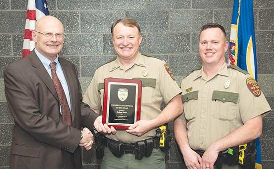 In 2017, Reller won the award for Conservation Officer of the Year. From left: DNR Commissioner Tom Landwehr, Officer Rick Reller, and Col. Rodmen Smith.