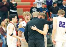 Buffalo seniors embrace Head Coach Josh Ortmann after receiving their Section 8AAAA runner-up trophy following last Thursday’s 54-52 loss to Maple Grove. Pictured (left-right): Brandon Maatz, Tony Dahl, Ortmann, Trevor Johnson, and Matthew Willert. (Photo by Rob LaPlante) 